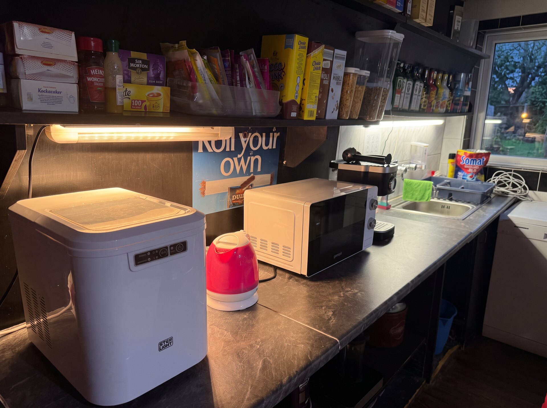 Guest kitchenette with ice maker, kettle, microwave and sink