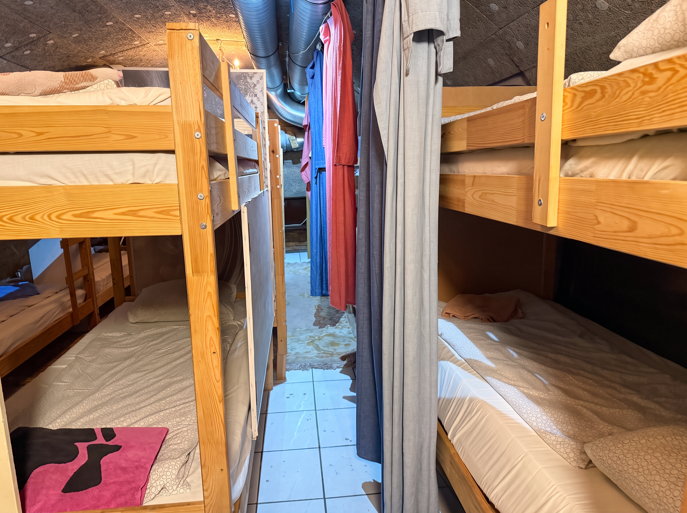 Bunk-bed aisle with towels and curtains for privacy