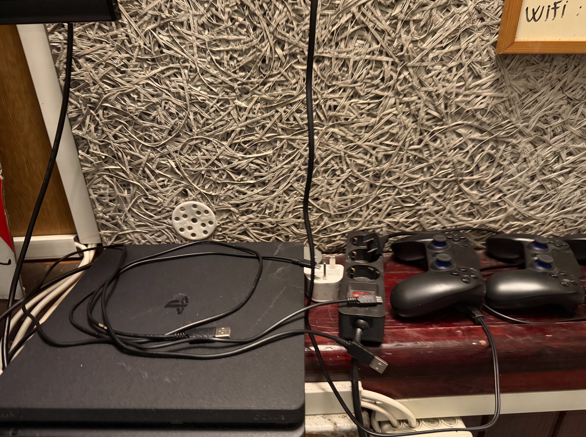 PlayStation console with two controllers