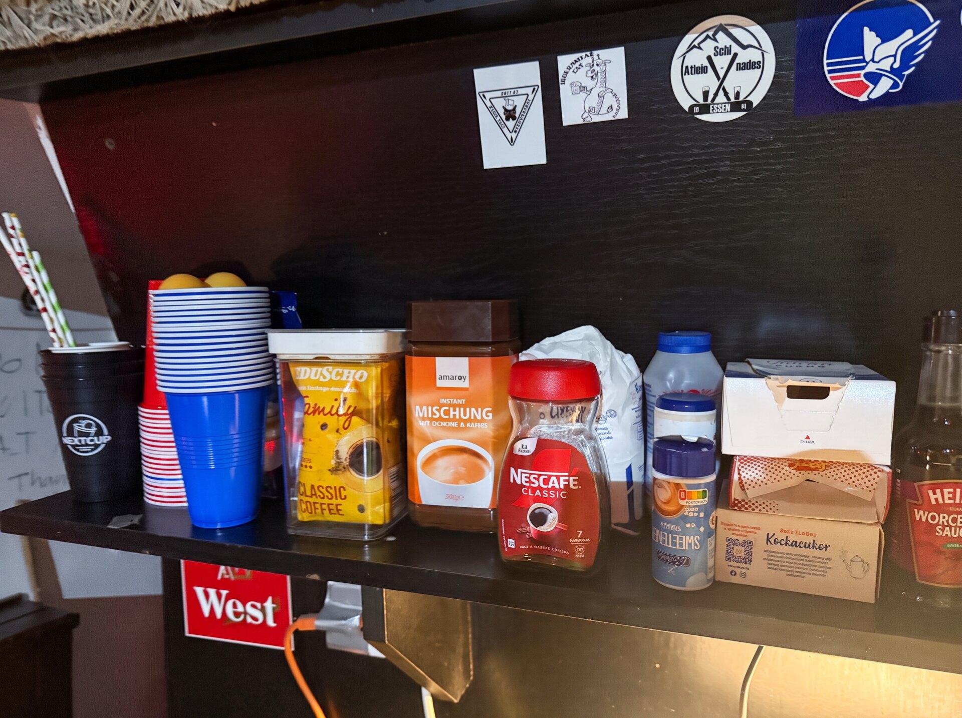 Self-service coffee station with cups and condiments