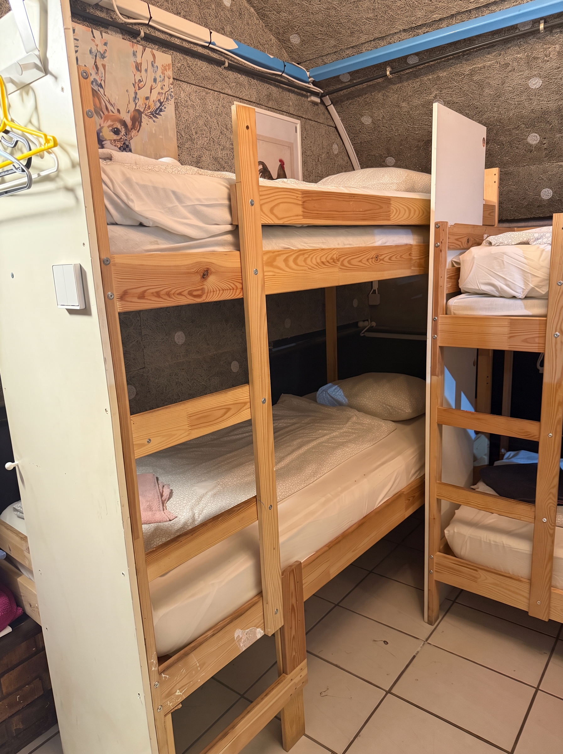 Wooden bunk beds with ladders and wall art